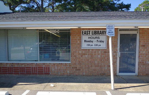 Photograph of the exterior of East Branch Library, a brick shopfront in a small strip mall